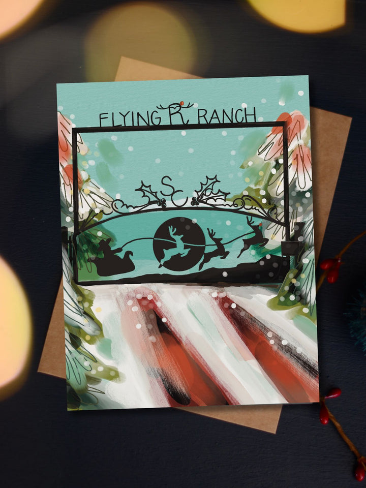 Santa's Flying R Ranch Christmas card in teal, featuring Santa's sleigh and reindeer flying over a ranch gate on a snowy road