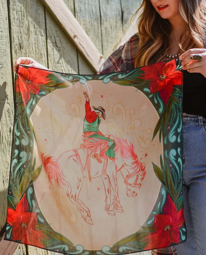 Poinsettia Bronc Rider 26x26 wild rag held open to show the full design