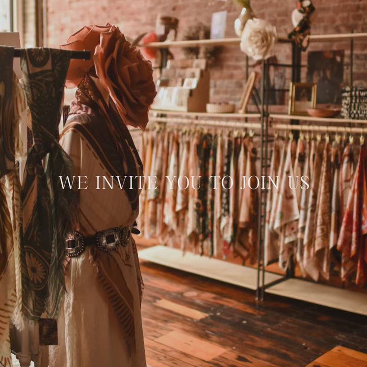 Tirzah Lane video: wild rags displayed on racks in a brick-walled shop, with the words We invite you to join us